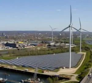 Wind turbines at Windpark Koningspleij connected to shore power infrastructure, forming a hybrid green energy hub.