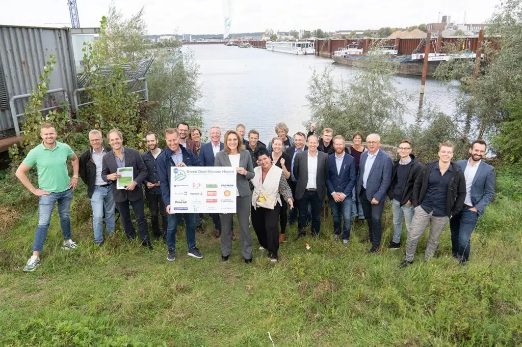 Team of experts discussing renewable energy grid solutions at the Koningspleij energy hub site.
